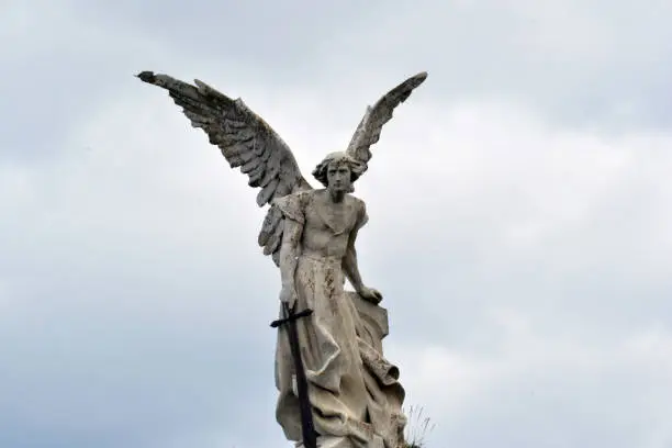 Forntal view of a statue of the archangel San Miguel in a cemetery