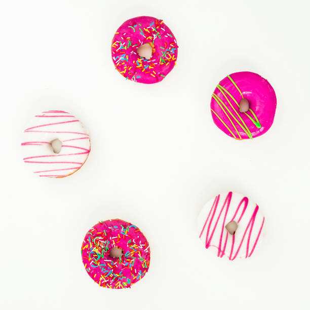 istock Round frame made of colorful bright donuts on white background. Flat lay, top view 868535488