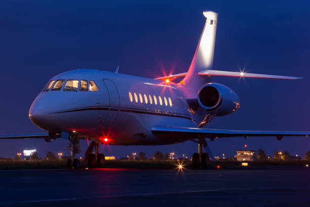 Large modern private business jet ready to take off at night stock photo