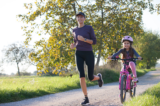 Mother and daughter enjoying together leisure sports activity.