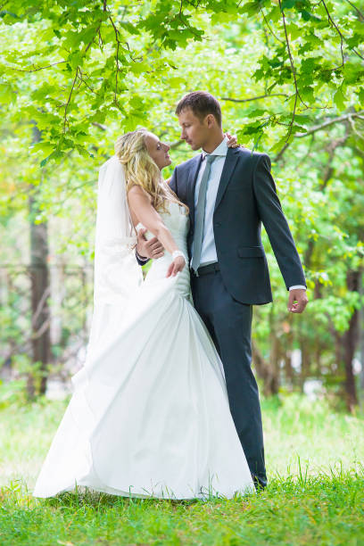 istock Wedding. Happy bride and groom in park 868547864