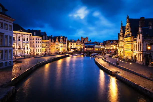 Photo of Graslei street and canal in the evening. Ghent, Belgium