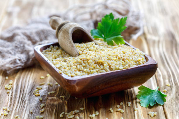 istock Organic raw bulgur in a wooden bowl. 868555840
