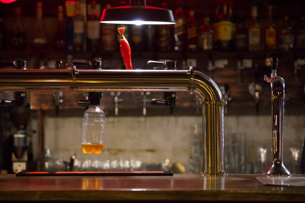 istock bar counter with beer cranes on background  wall with bottles 868557092
