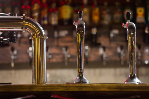 istock bar counter with beer taps on wall background with bottles 868558070