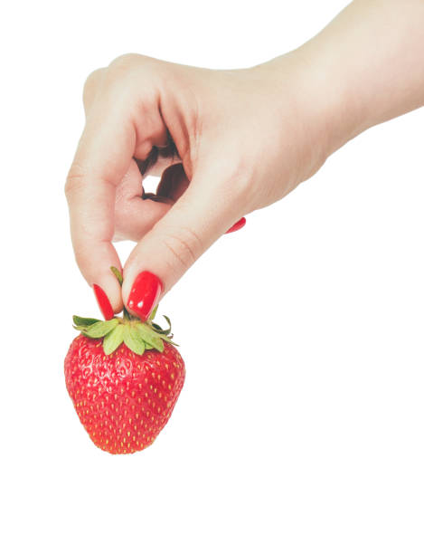 istock strawberries in hand isolated on white background 868559490
