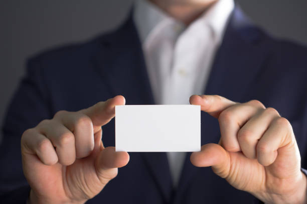 istock man with blank business card 868561814