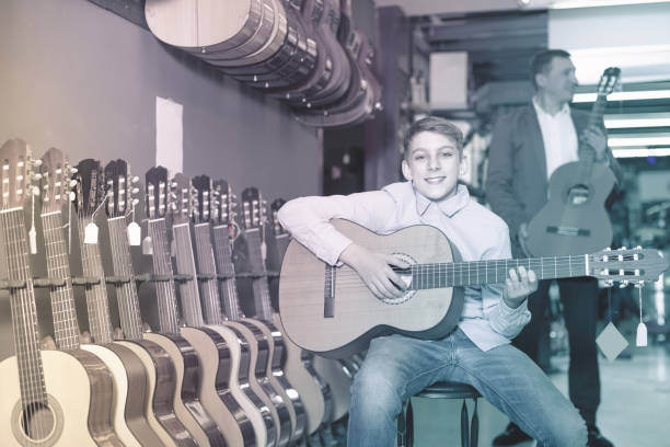 istock Boy listening to guitar sound 868565110