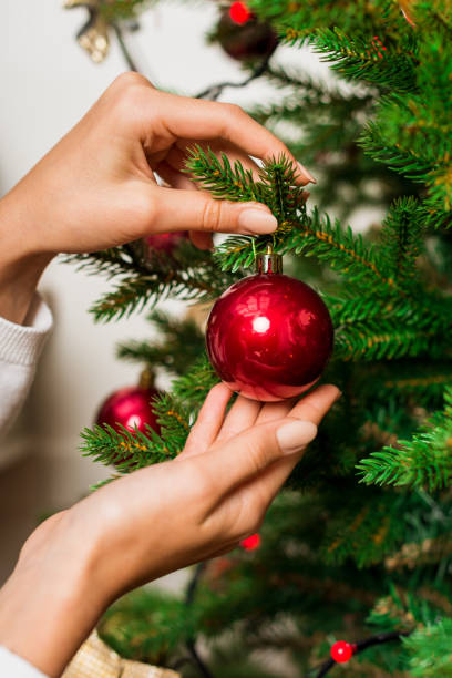 istock woman decorating christmas tree 868572206
