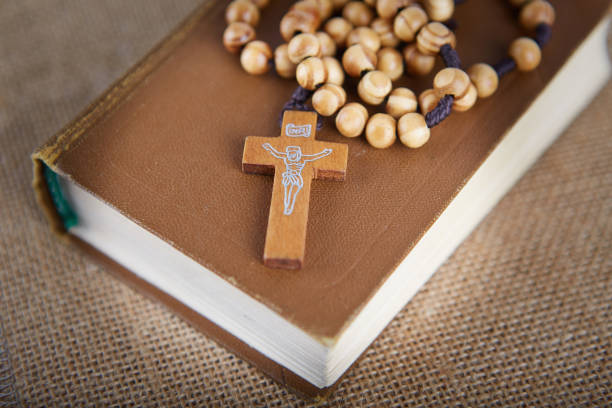 istock Bible and wooden rosary arranged on an old fabric. 868574718