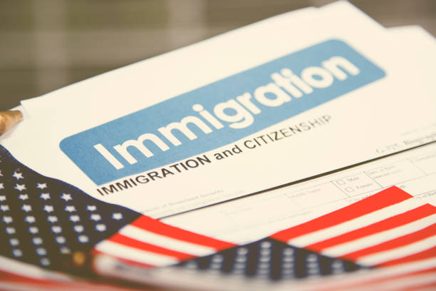 istock American immigration, citizenship forms with USA flag. 868575364