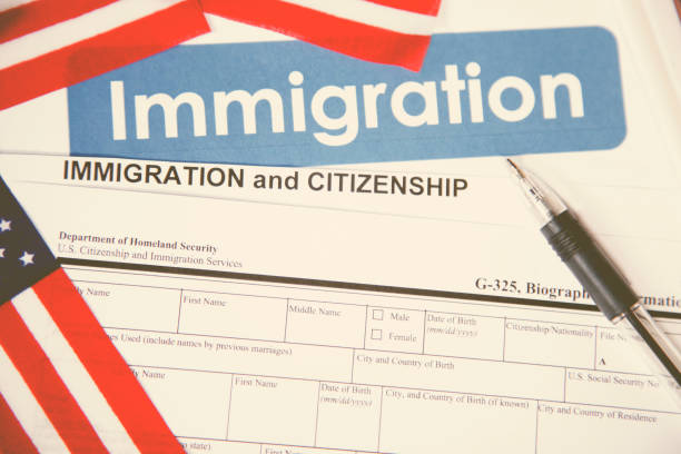 istock American immigration, citizenship forms with USA flag. 868575440