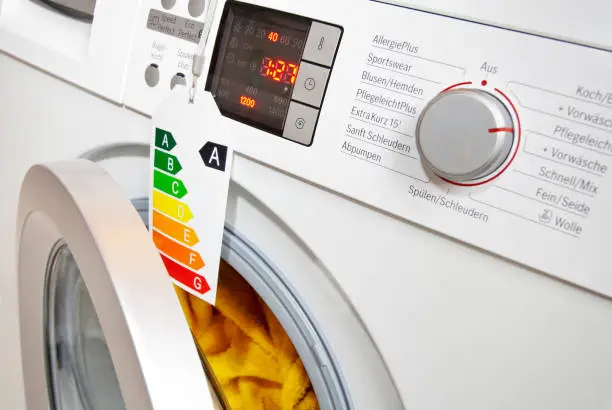 Modern washing machine with eco-label, which shows the efficiency class A.