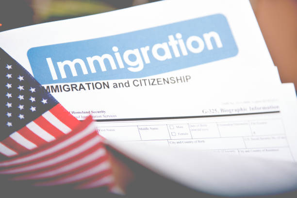 istock American immigration, citizenship forms with USA flag. 868575836