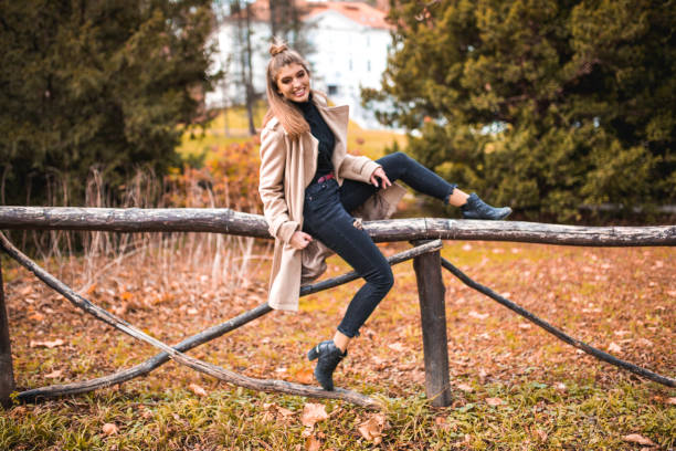 istock Woman sitting on a fence 868575986