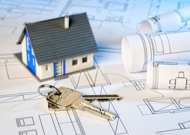 istock Building plans with house and keys 868576010