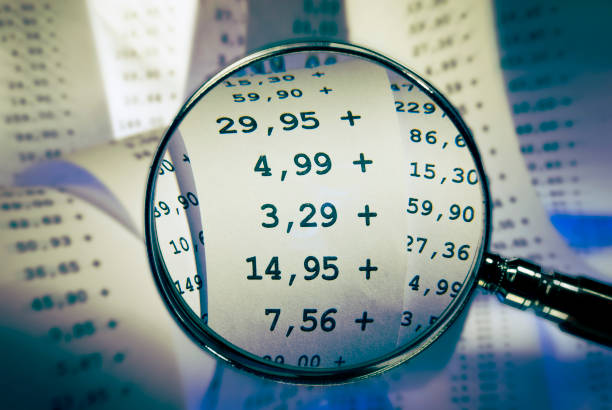 istock Magnifier focuses sums on a cash receipt 868576036