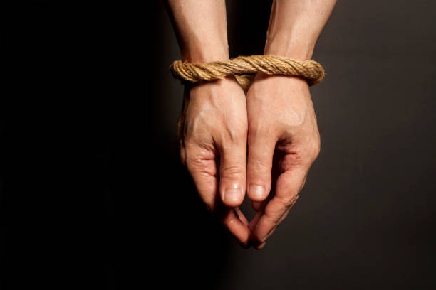 istock Male hands bound with rope. Addiction concept. 868579984