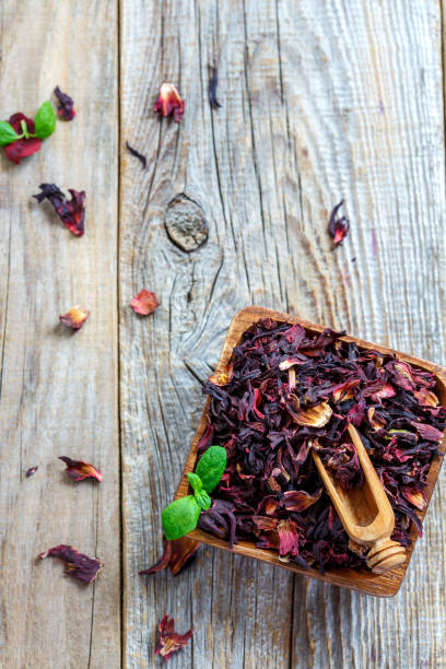 istock Petals Hibiscus tea in a wooden bowl. 868584508