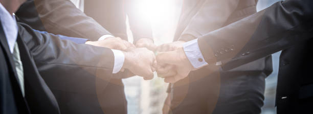 istock Business people group of hands making fist bump teamwork Join Hands Support together successful Concept. 868584796