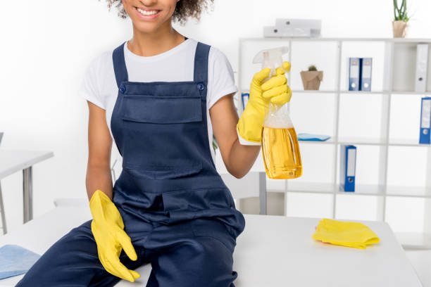 istock african american cleaner with spray bottle 868584828