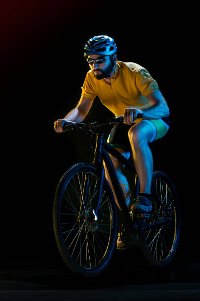 istock The bicyclist on black, studio shot 868587152