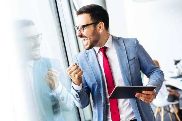 istock Handsome businessman working in modern office on a digital tablet 868591980