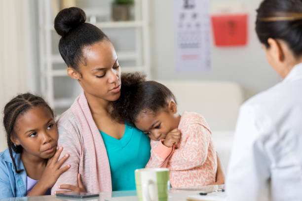 istock Concerned mother takes daughters to pediatrician 868595682
