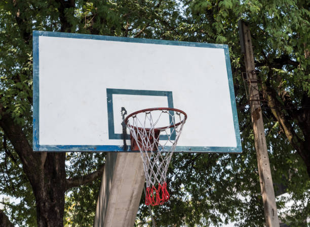 istock Old basketball hoop on the concrete pole. 868602162