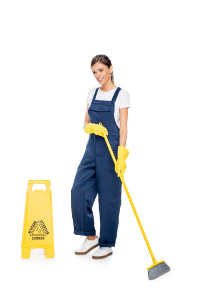 istock smiling cleaner in uniform with broom 868603630