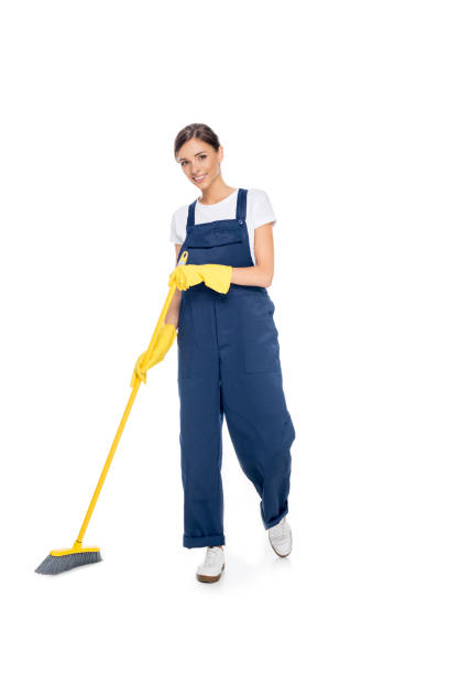 istock smiling cleaner in uniform with broom 868603698