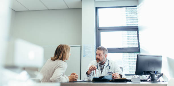 istock Doctor explaining diagnosis to female patient 868603896