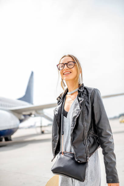 istock Woman near the airplane 868608062