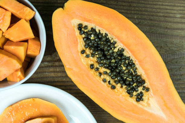 istock Papaya cut in half with pieces in bowl 868611596