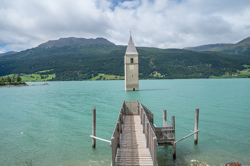 Beautiful view of a flooded church in Lago di Resia, northern Italy also called Reschensee, lake Reschen. 