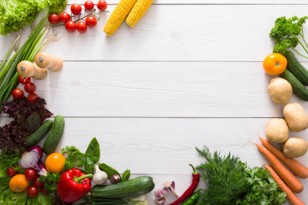 istock Border of fresh vegetables on white wood background with copy space 868615618