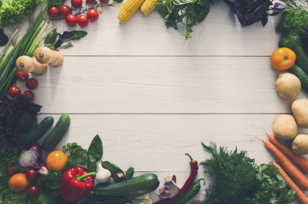 istock Fresh vegetables border on white wood background with copy space 868618050