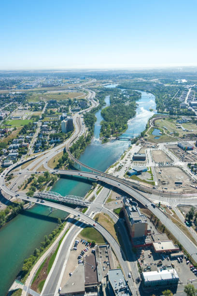 Aerial view of highways crossing the river. Bow river, Calgary, Alberta. An aerial photo of Bow River during summer in Calgary. bow river stock pictures, royalty-free photos & images