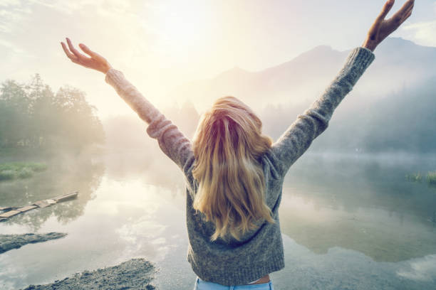 Body positive girl enjoying freedom in nature Young woman feeling the freedom in nature, embracing the environment. Female arms outstretched, body positive. People freedom success concept potential energy stock pictures, royalty-free photos & images