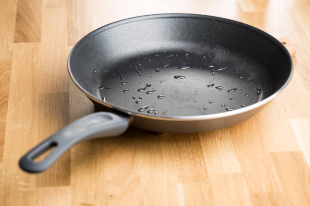 istock Teflon frying pan on wooden table 868623612