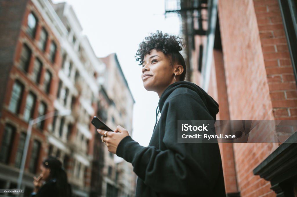 Young Woman Enjoying City Life in New York A young African American woman spends time in New York city, exploring Manhattan. People Stock Photo