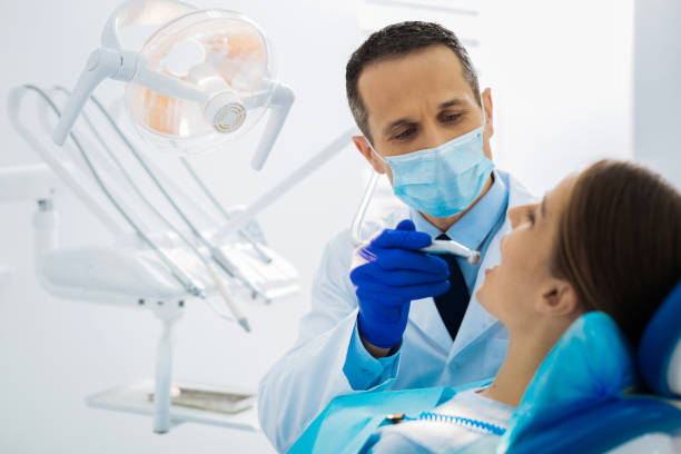 istock Professional experienced dentist treating his patients teeth 868626666