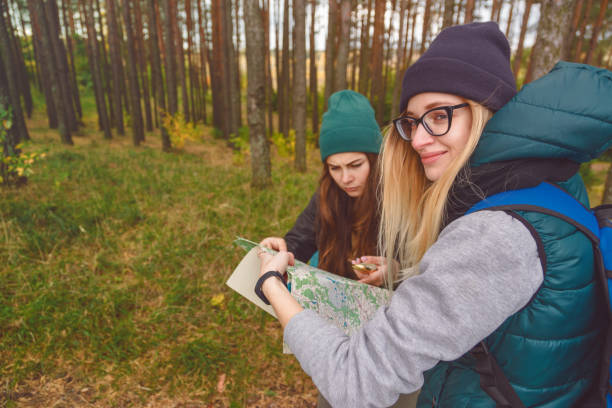 istock Two young tourist determine the route map and compass. 868627520