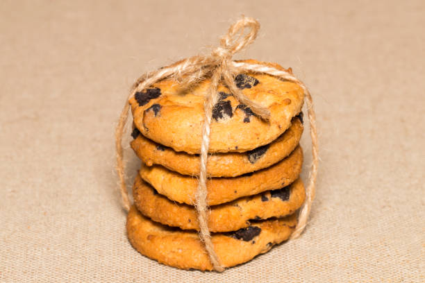 istock Chocolate cookie pieces and crumbs on background burlap 868634620