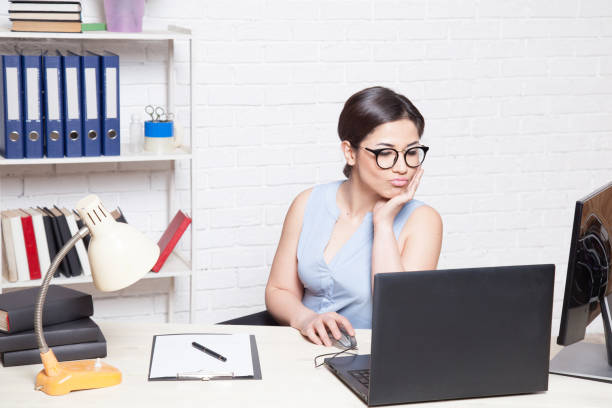 istock business girl sits in an Office behind a desk with a computer 868640024