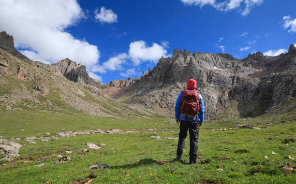 istock woman hiker with backpack hiking at high altitude mountains 868651110