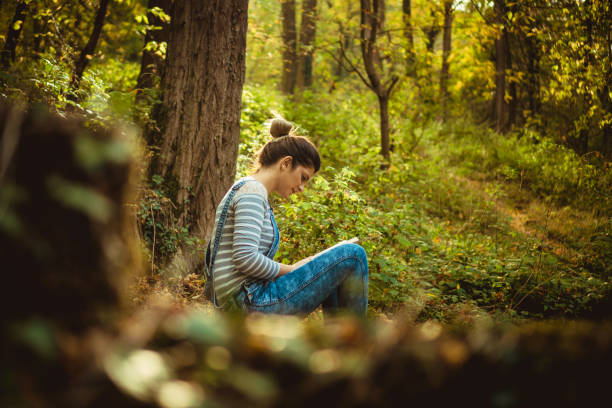 istock Relaxing with a good book in forest 868656666