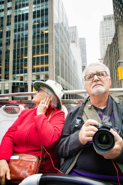 istock Senior couple visiting Manhattan on a tour bus 868658846