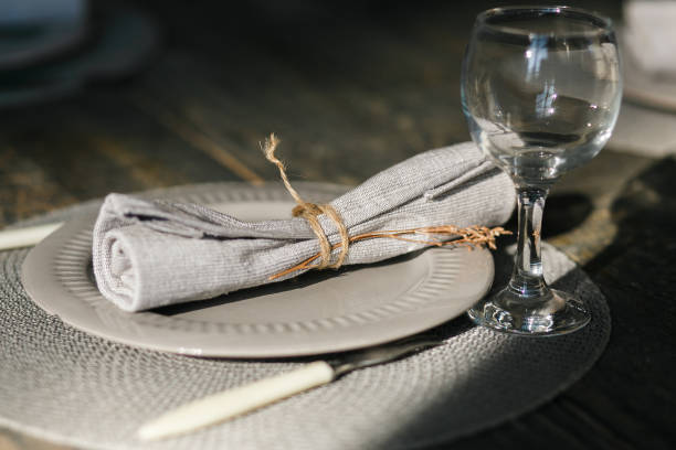 istock Table setting. One grey plate. Knife and fork. Old fashioned wine glass. Rustic napkin. Wooden table. Selective focus 868659080