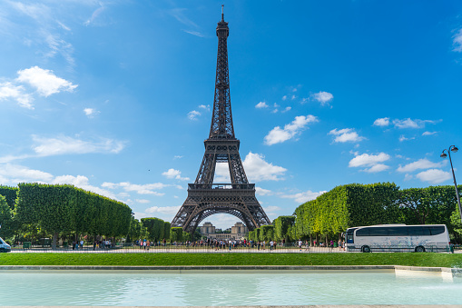 view of Eiffel Tower and green bus with tourists visiting Paris city